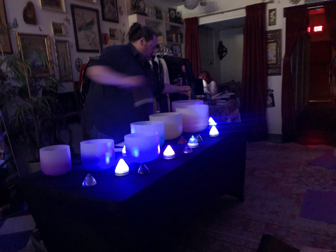 Candlelit crystal singing bowls set up for a sound bath in Madison Heights, Michigan